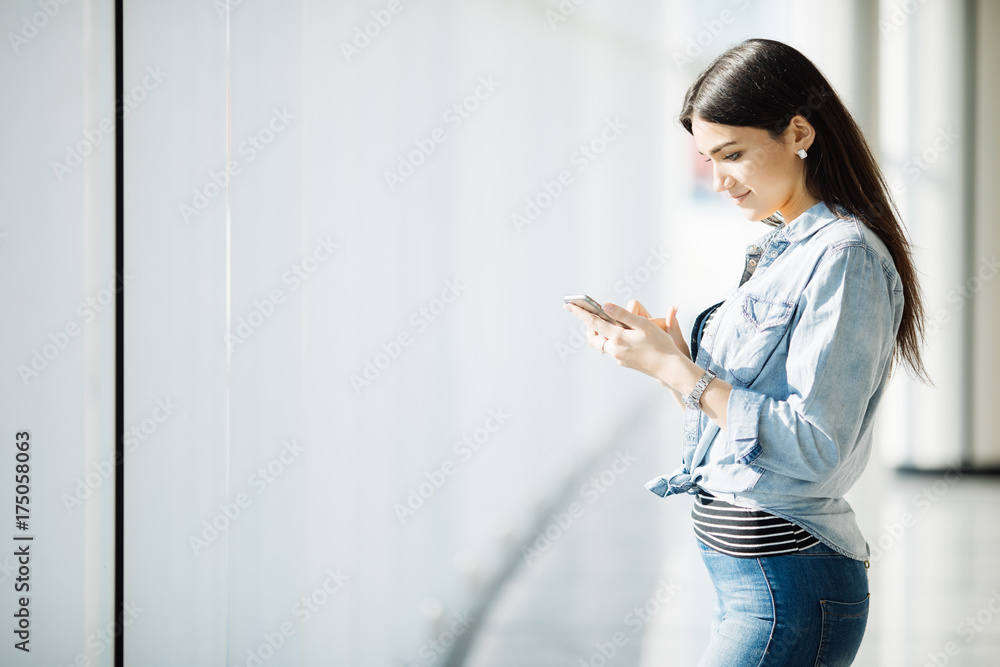 Beautiful woman use the phone at the window. Beautiful woman use the phone at the window.