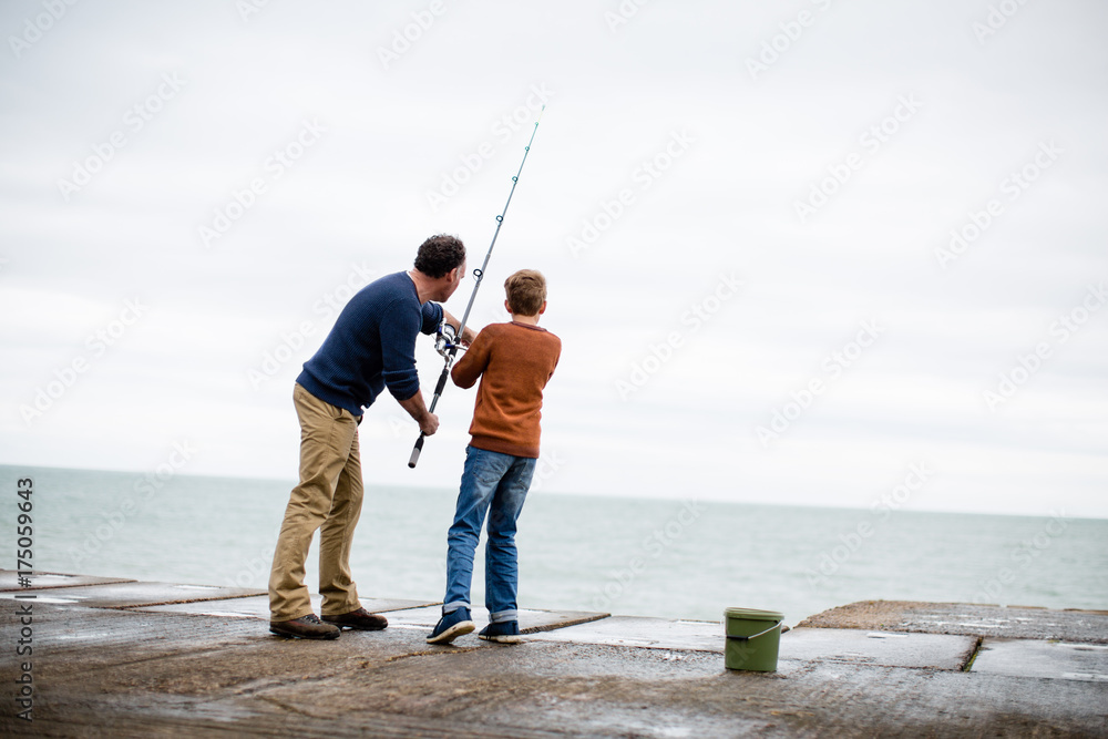 Father helping Son fish