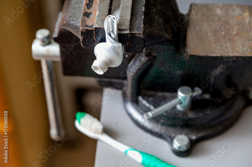 Fényképezés Twisted tube of toothpaste squeezed in bench screw