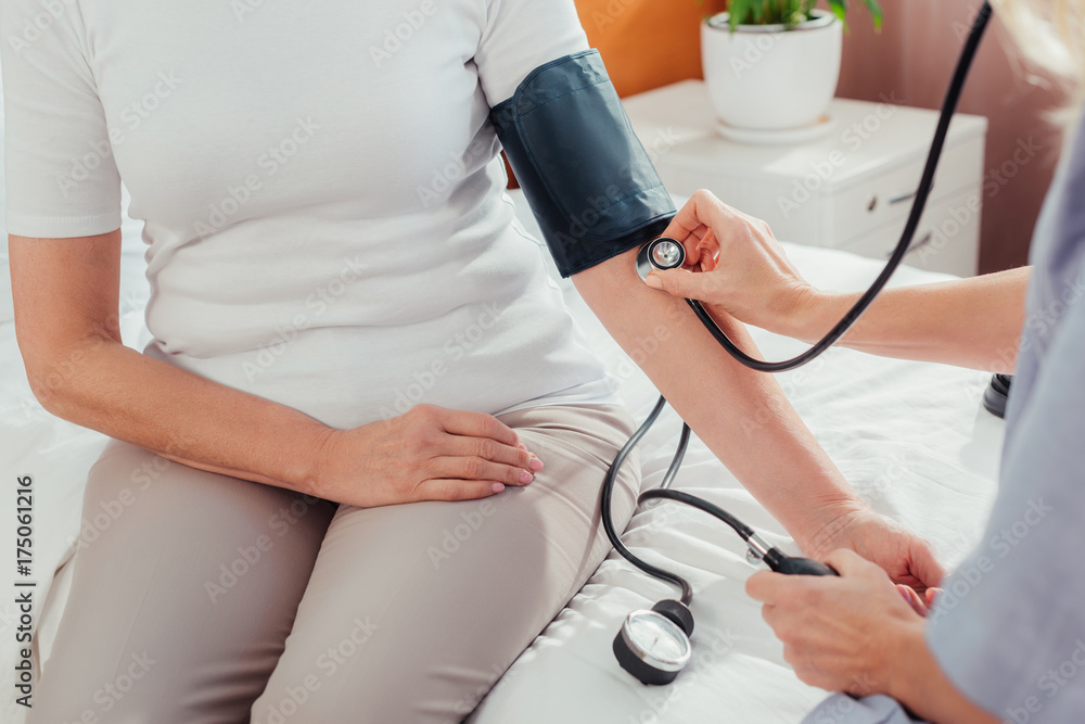 nurse measuring blood pressure to patient nurse measuring blood pressure to patient