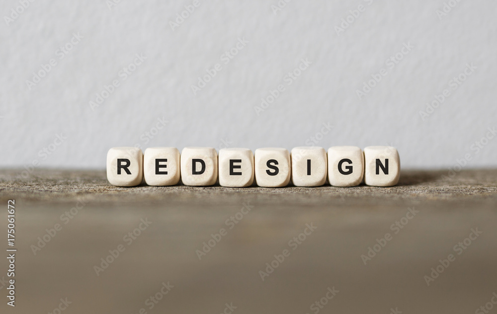 Word REDESIGN made with wood building blocks - obrazy, fototapety, plakaty 