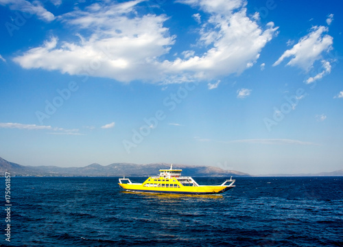 yellow ferryboat for the transport of people and cars