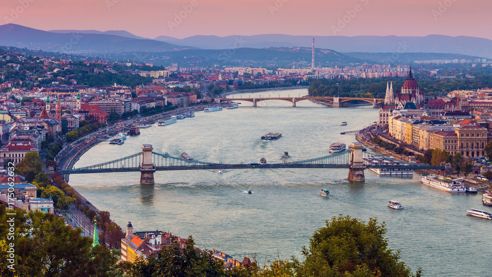Budapest, Hungary - Panoramic skyline view at sunset of the famous Szechenyi Chain Bridge, Margaret Bridge, Margaret Island and Parliament of Hungary with Buda Hills at background with colorful sky
