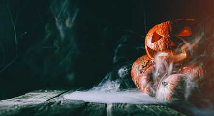 Pumpkin to celebrate Halloween on a wooden background