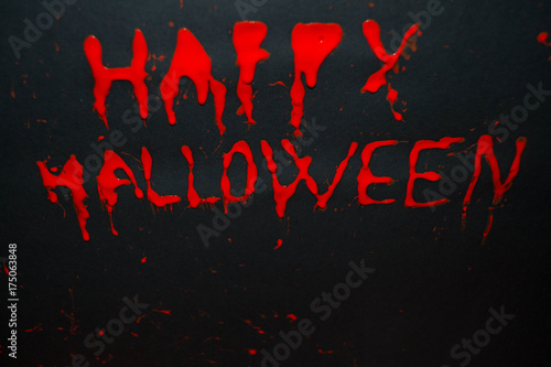 Happy halloween red words on black background. Happy Halloween text with paint or spray. Halloween inscription. Banner.