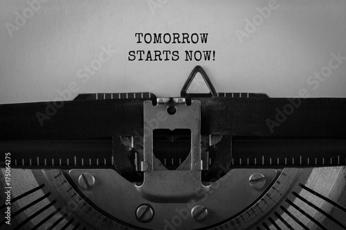 Text Tomorrow starts now typed on retro typewriter photo