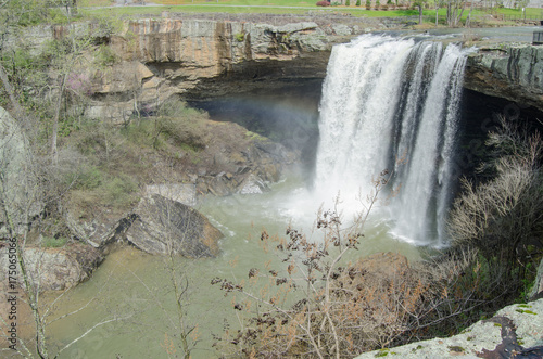 A rainbow can be seen as water cascades over Noccalula Falls after late winter rains in Gadsden, Alabama, USA photo