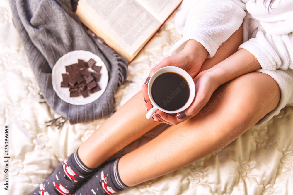 Girl with a cup of coffee in bed