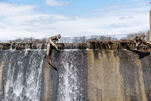 Small dam with running water fall in Accotink park in Fairfax, Virginia photo