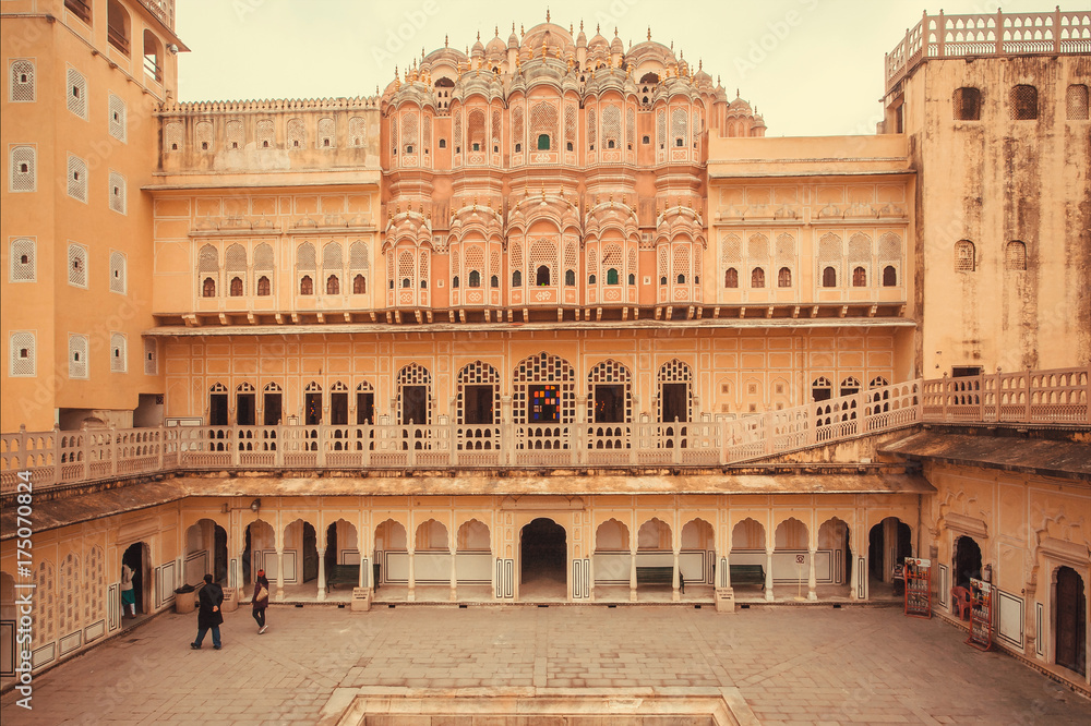 Beautiful courtyard with tourists and walls of Hawa Mahal - Palace of Winds - built in 1799