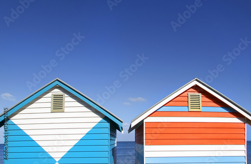 Two vibrantly painted beach huts on Melbourne's Brighton Beach