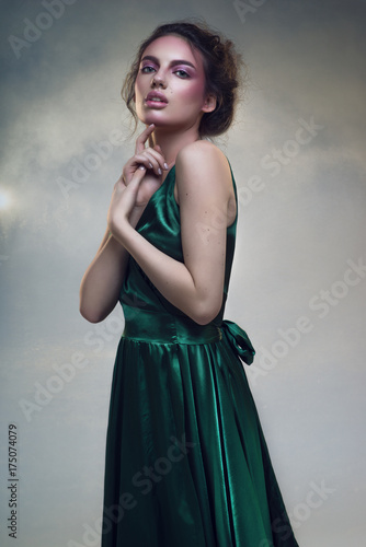 Portrait of beautiful woman in fashion green dress