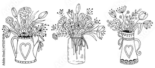 Three vases with floral bouquets.