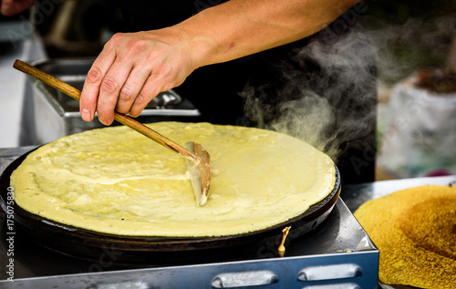 Making of crepes pancakes in open market festival fair. photo