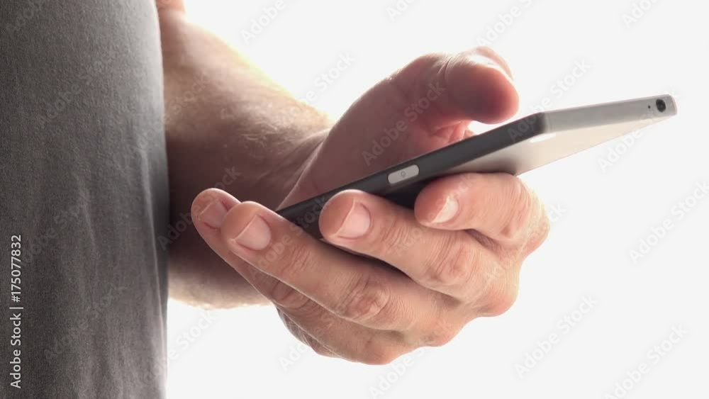 Man using smart phone. Close up of hands scrolling page of mobile app with thumb. Man using smart phone. Close up of hands scrolling page of mobile app with thumb.