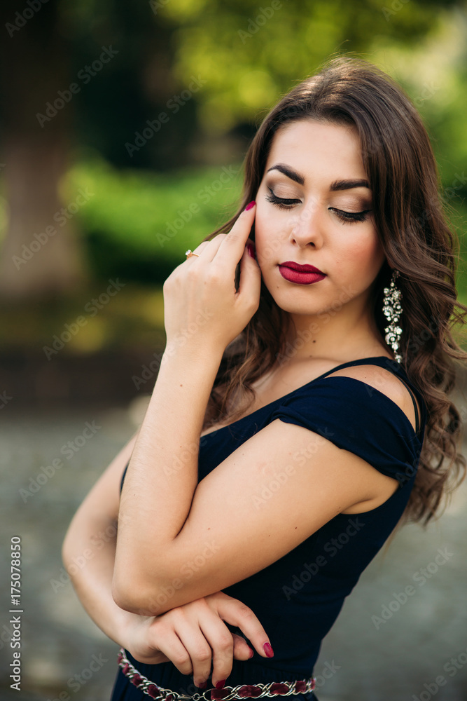 A beautiful girl in a dress is walking around the city. A beautiful girl in a dress is walking around the city.