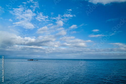 Calm morning sea landscape with cloudy sky and rocks. wide angle. Horizontal frame © Evgenii Iakovenko