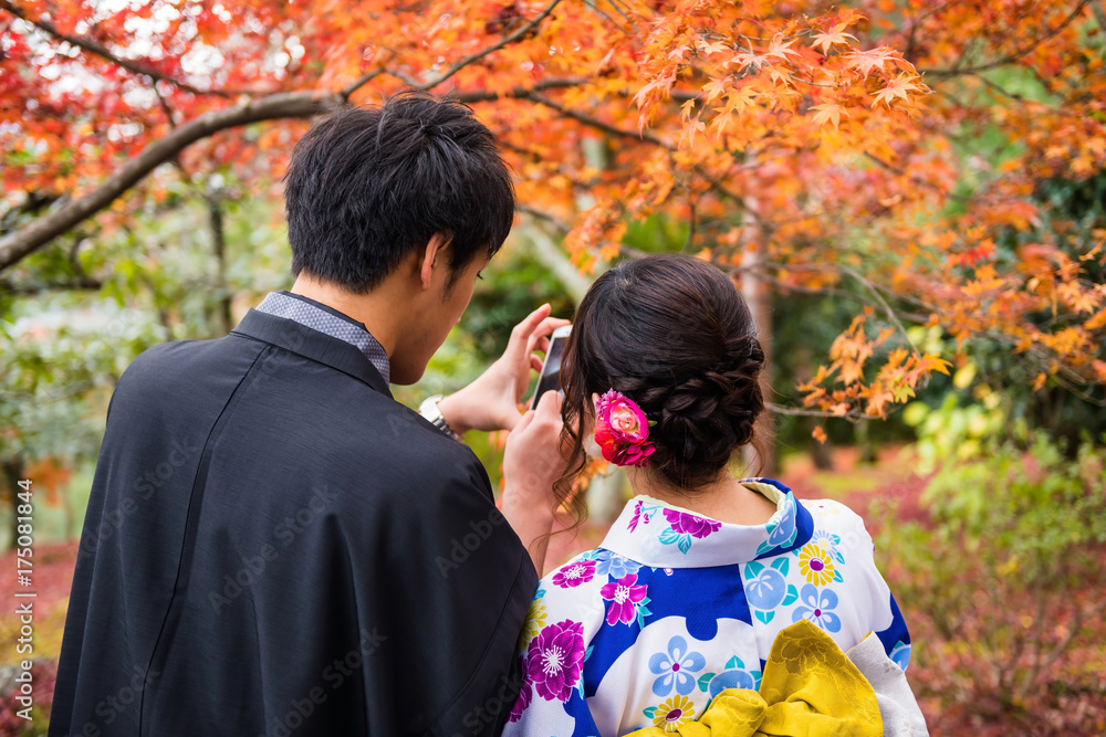 Japanese couplt selfie with autumn leaf, Arashiyama Japanese couplt selfie with autumn leaf, Arashiyama