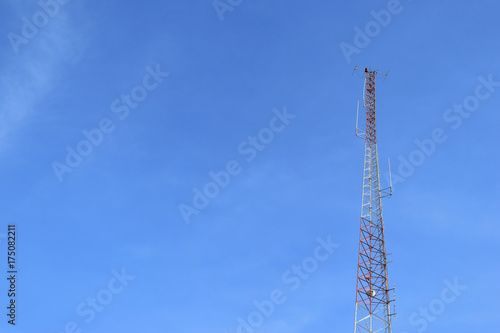 Antenna tower at blue sky and white clouds on a beautiful day.