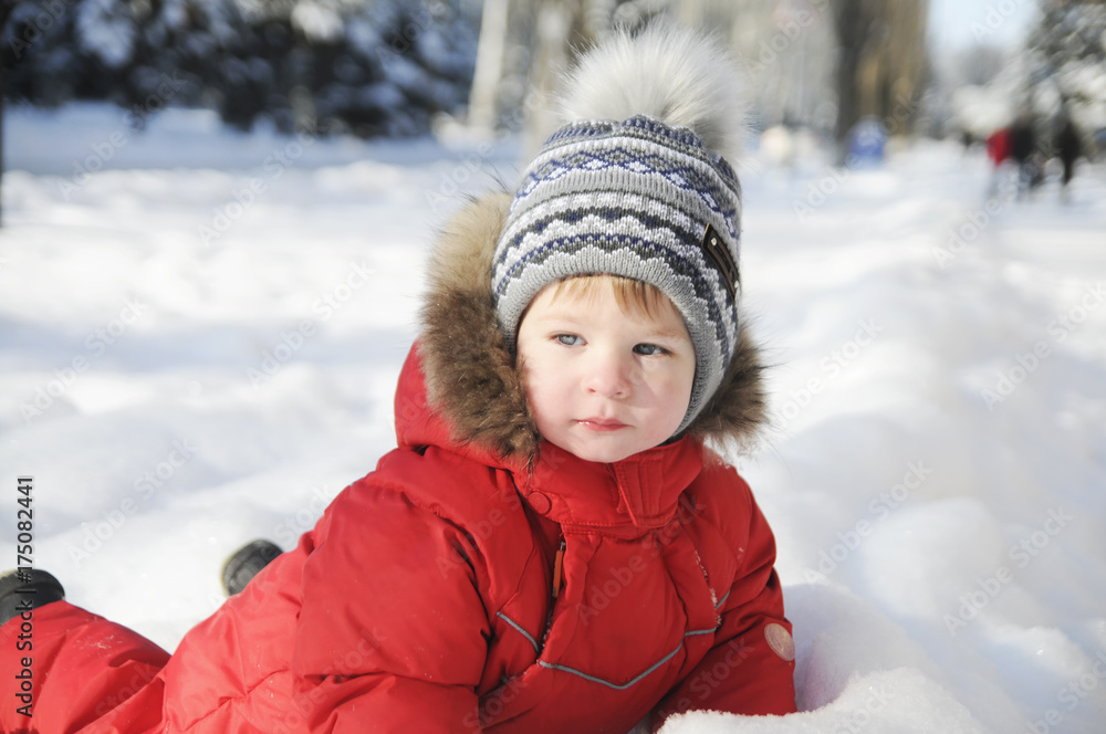 Portrait of a child in winter clothes, a walk through a winter park,