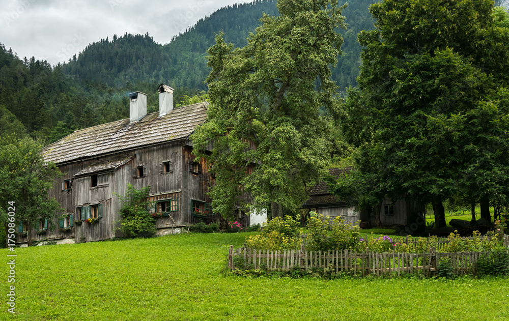 Old farmhouse in th alps on a cloudy day