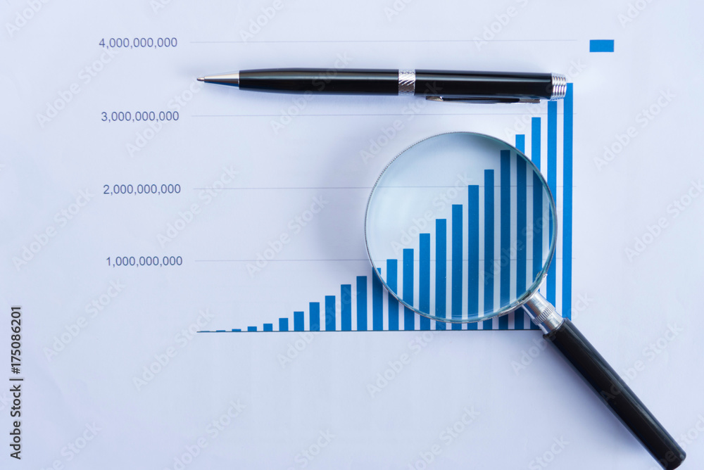 Checking financial reports. Graphs and charts. Documents and magnifying glass on gray reflection background. Checking financial reports. Graphs and charts. Documents and magnifying glass on gray reflection background.