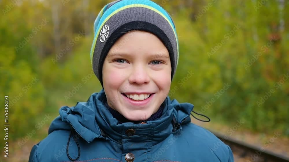 Child in autumn Park and smiling , walks in the fresh air. A beautiful scenic place Child in autumn Park and smiling , walks in the fresh air. A beautiful scenic place