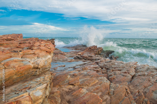 Big wave crashing on stone.
