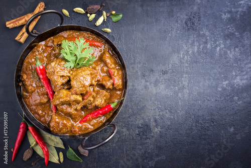 Traditional Indian curry lamb masala as close-up in a Korai with copy space right