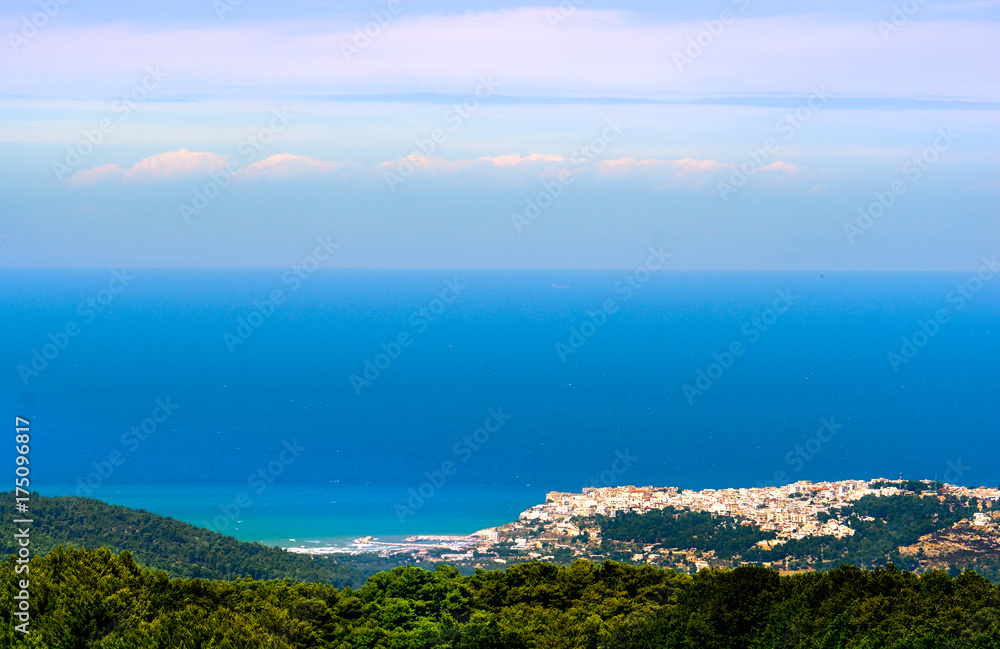 adriatic sea seascape panorama horizon with italian Peschici village in distance - Apulia - Gargano - Italy
