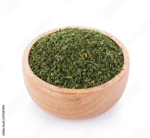dried parsley in bowl isolated on white background