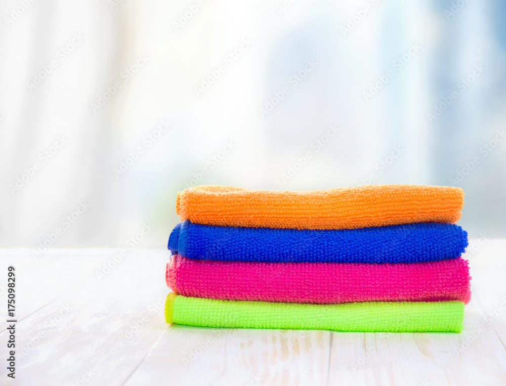A stack of towels on a wooden table A stack of towels on a wooden table