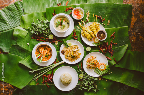 Variety of authentic thai traditional meal set on green banana leaves photo