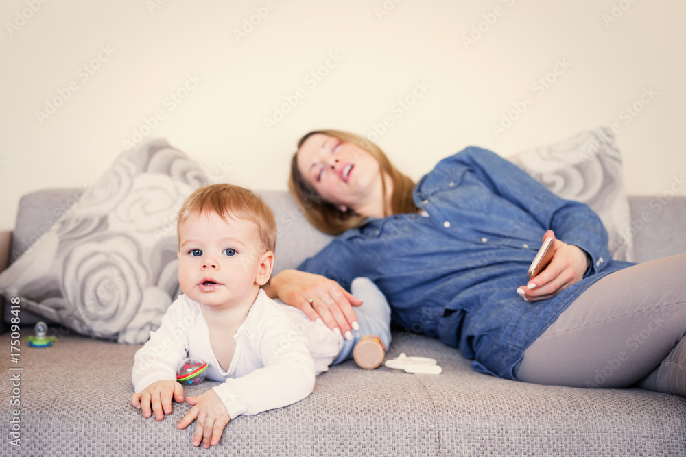 Baby playing while mother is sleeping Baby playing while mother is sleeping