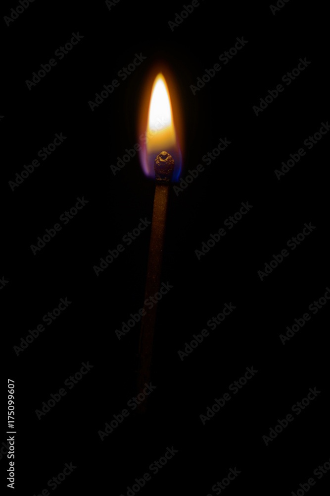 one burning match on a black background one burning match on a black background