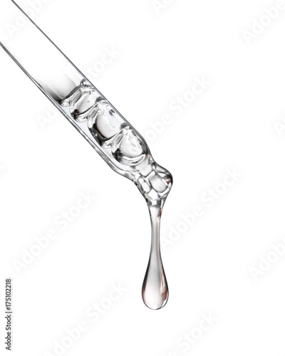 Cosmetic pipette with a drop close up on white background photo
