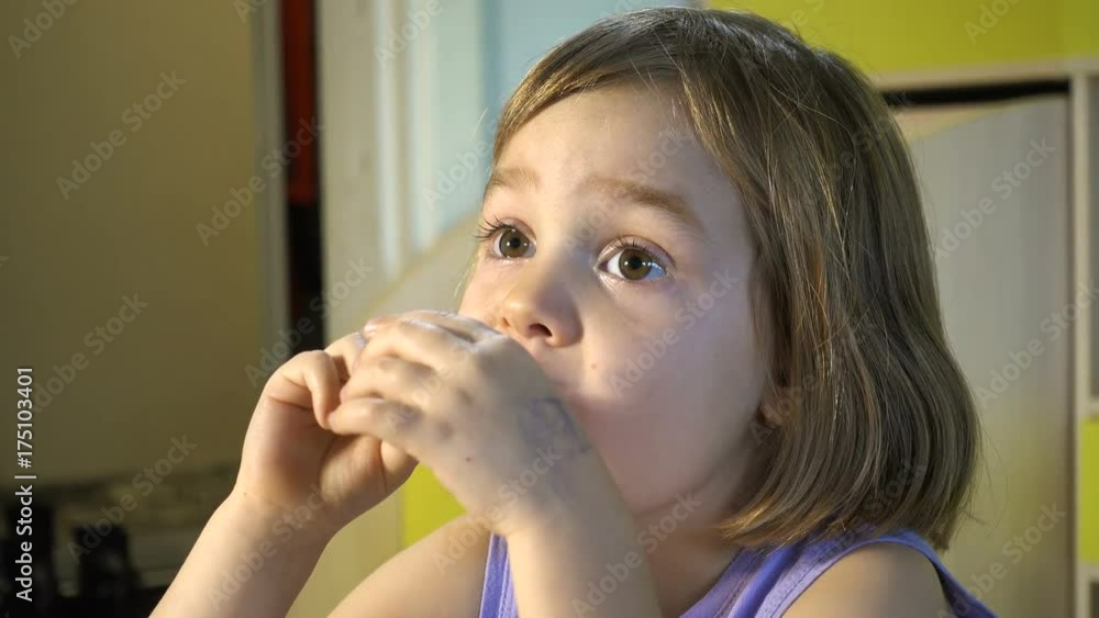 A girl of 4-5 years of European appearance eats pancakes. A girl of 4-5 years of European appearance eats pancakes.