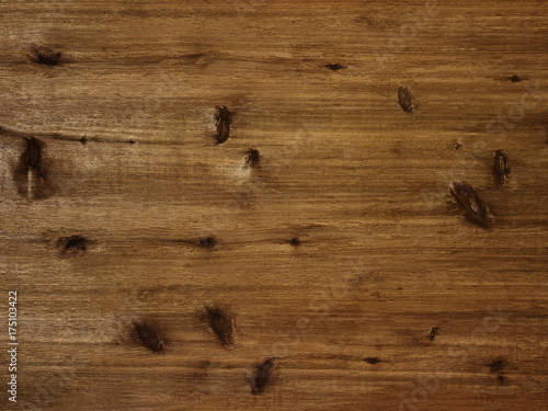 Rustic warm brown wood board background with knots and grain