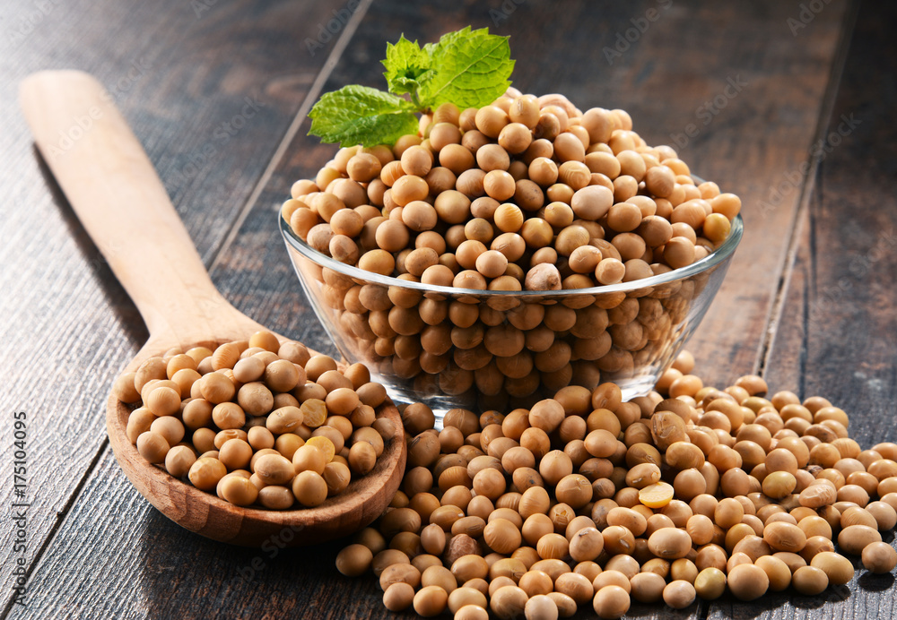 Composition with bowl of soya beans on wooden table Composition with bowl of soya beans on wooden table
