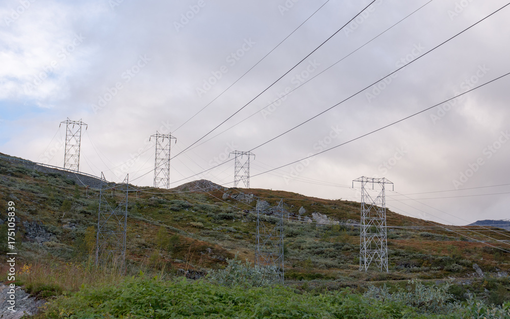 Fototapeta premium Hydro electric power lines crossing mountainn