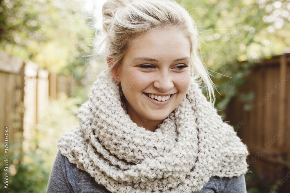 Laughing young woman wearing cream knit scarf Laughing young woman wearing cream knit scarf