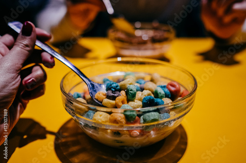 .Having a bowl of cereal with milk for breakfast. Lifestyle photography.