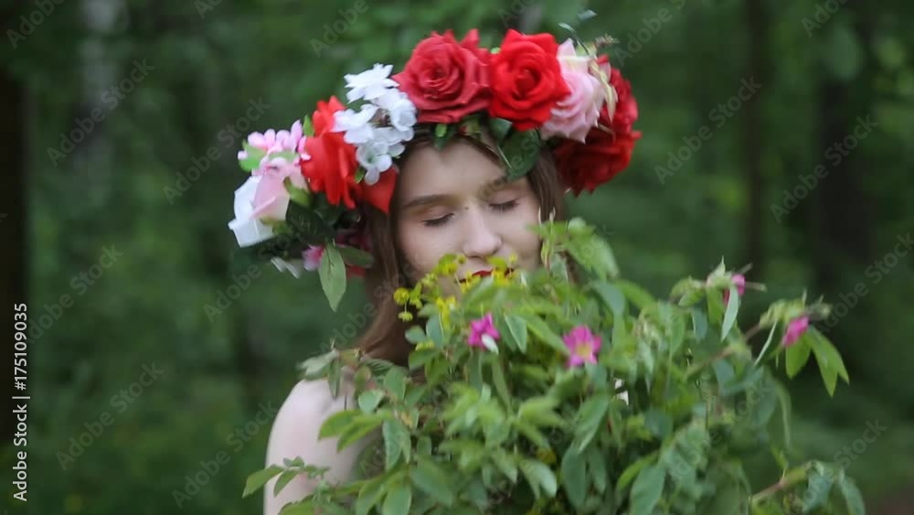 Beautiful girl with a wreath of flowers on her head Beautiful girl with a wreath of flowers on her head