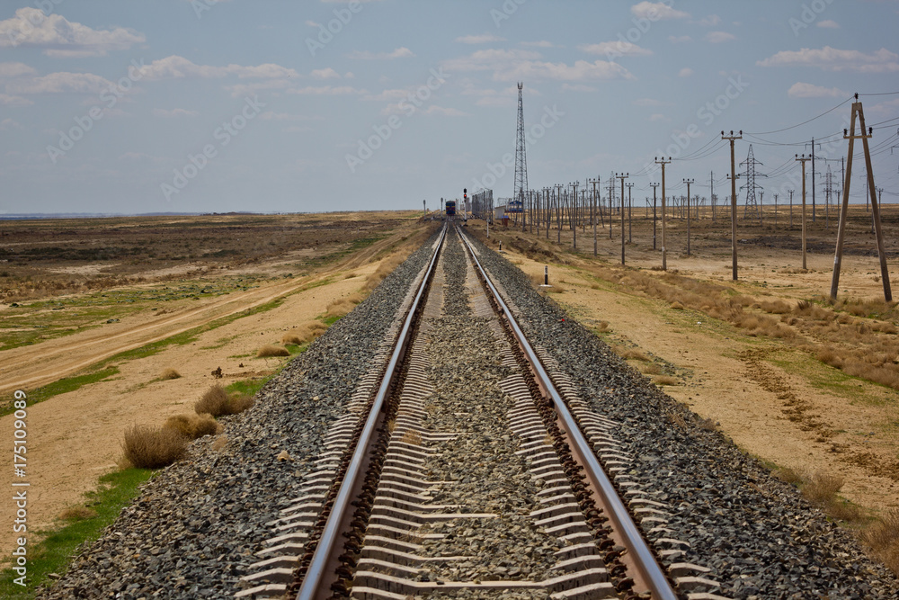 Railroad track leading through the desert Railroad track leading through the desert