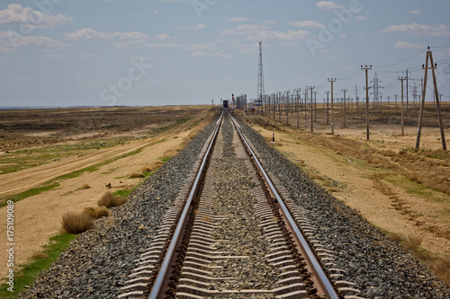 Railroad track leading through the desert