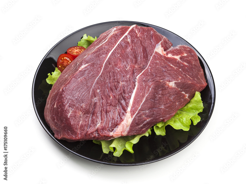 Piece of raw beef on plate isolated on white background