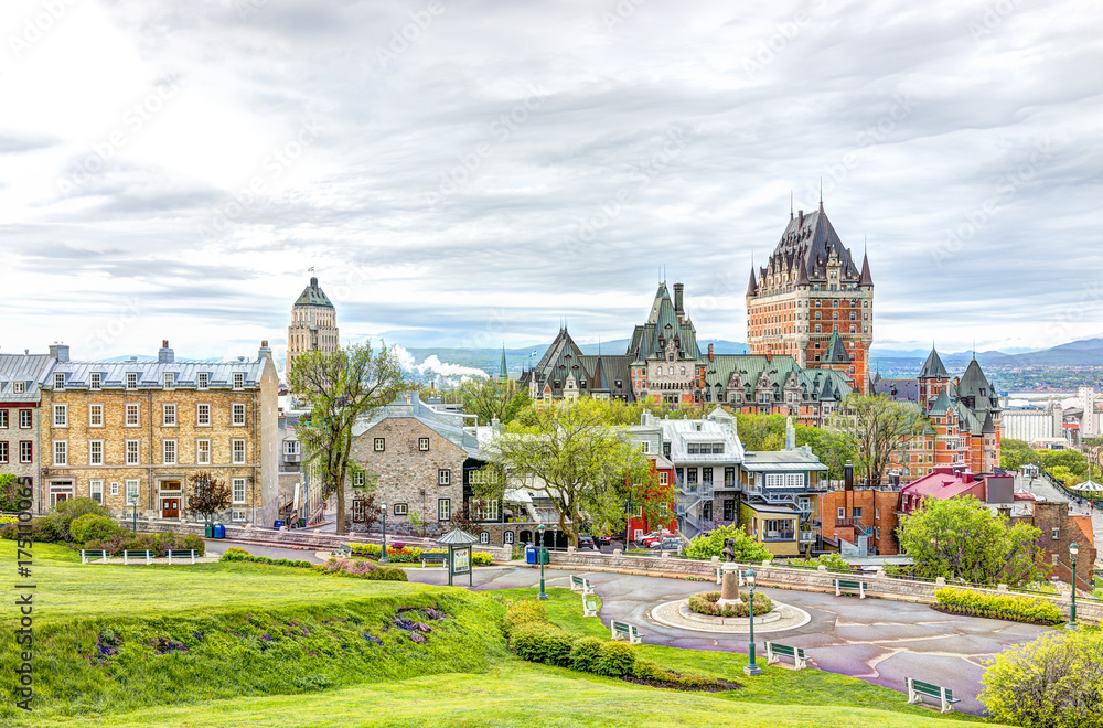 Cityscape or skyline of Chateau Frontenac, park and old town streets during sunset