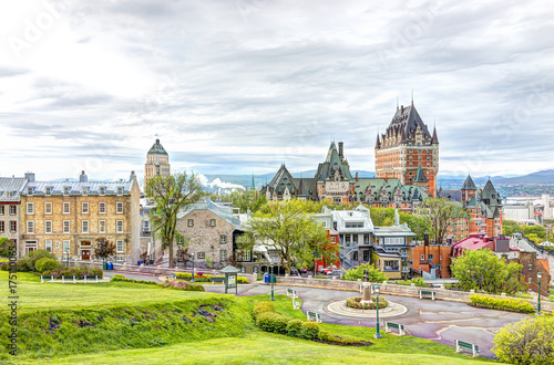 Cityscape or skyline of Chateau Frontenac, park and old town streets during sunset photo