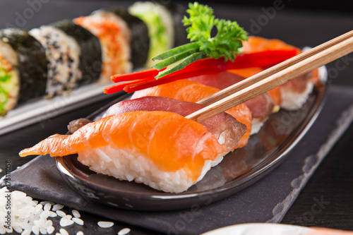 Japanese sushi set on a rustic dark background.