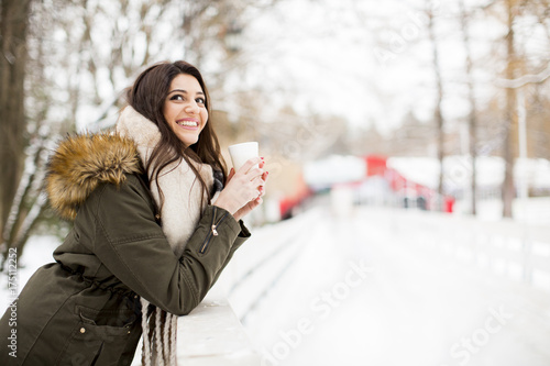 Pretty young woman drinking...